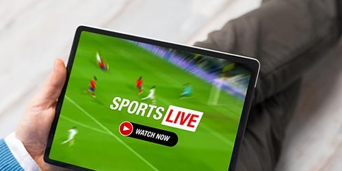 Man watching sports streaming live on digital device